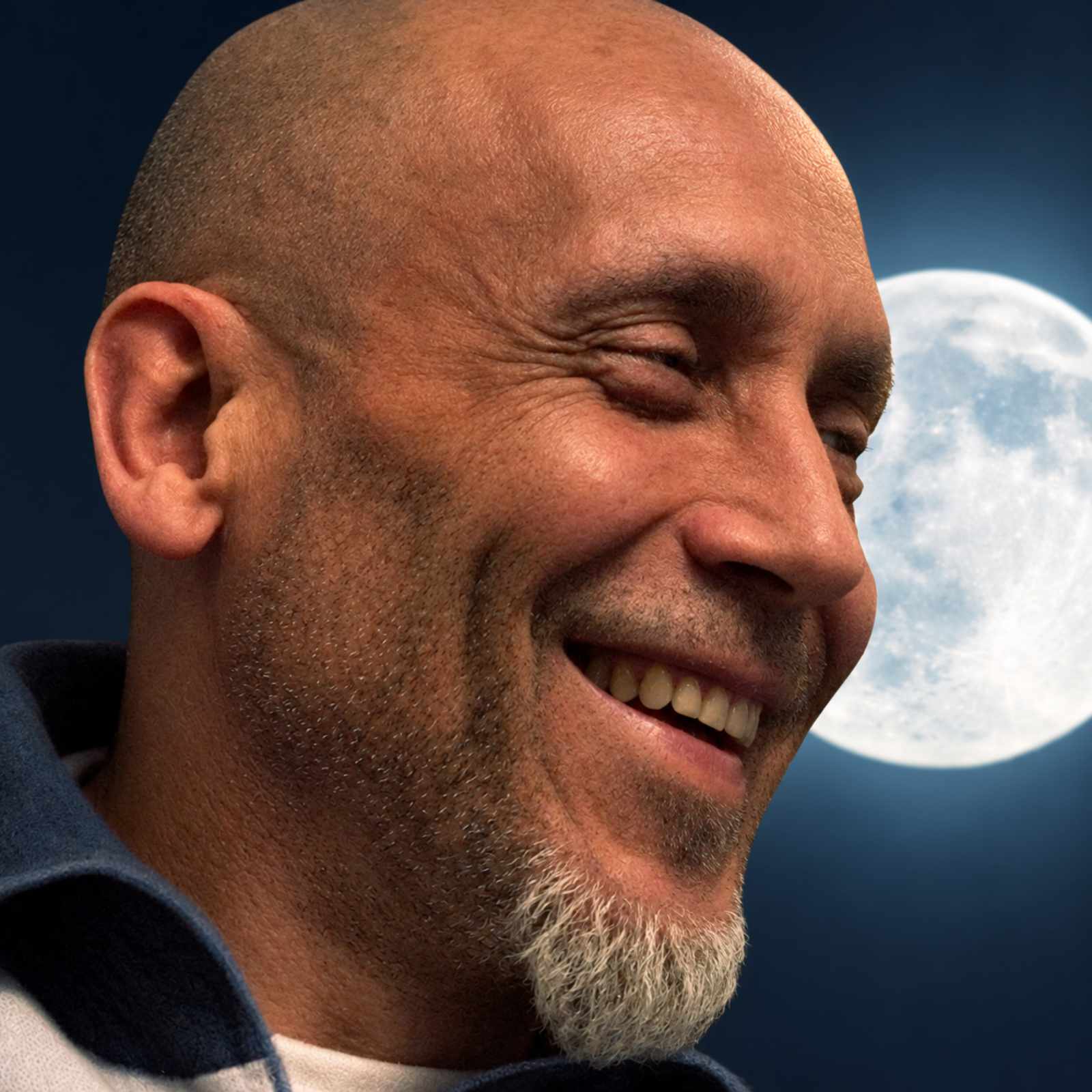 Luis Santiago Pinto smiling, with the moon behind him